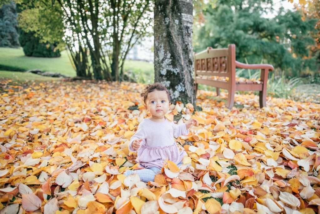 Playing in autumn leaves