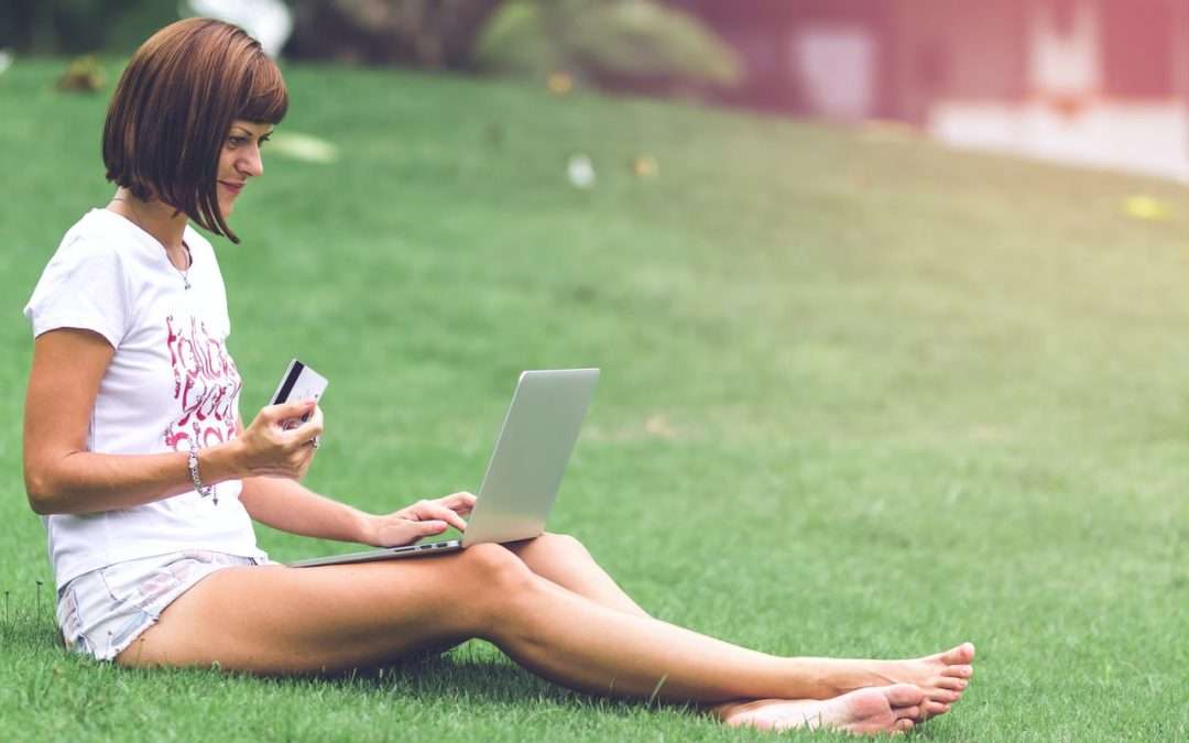 Woman sitting in lawn ordering online